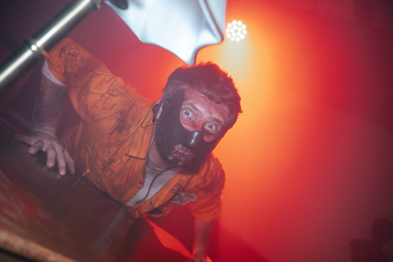 Performer lunging at the camera in red light