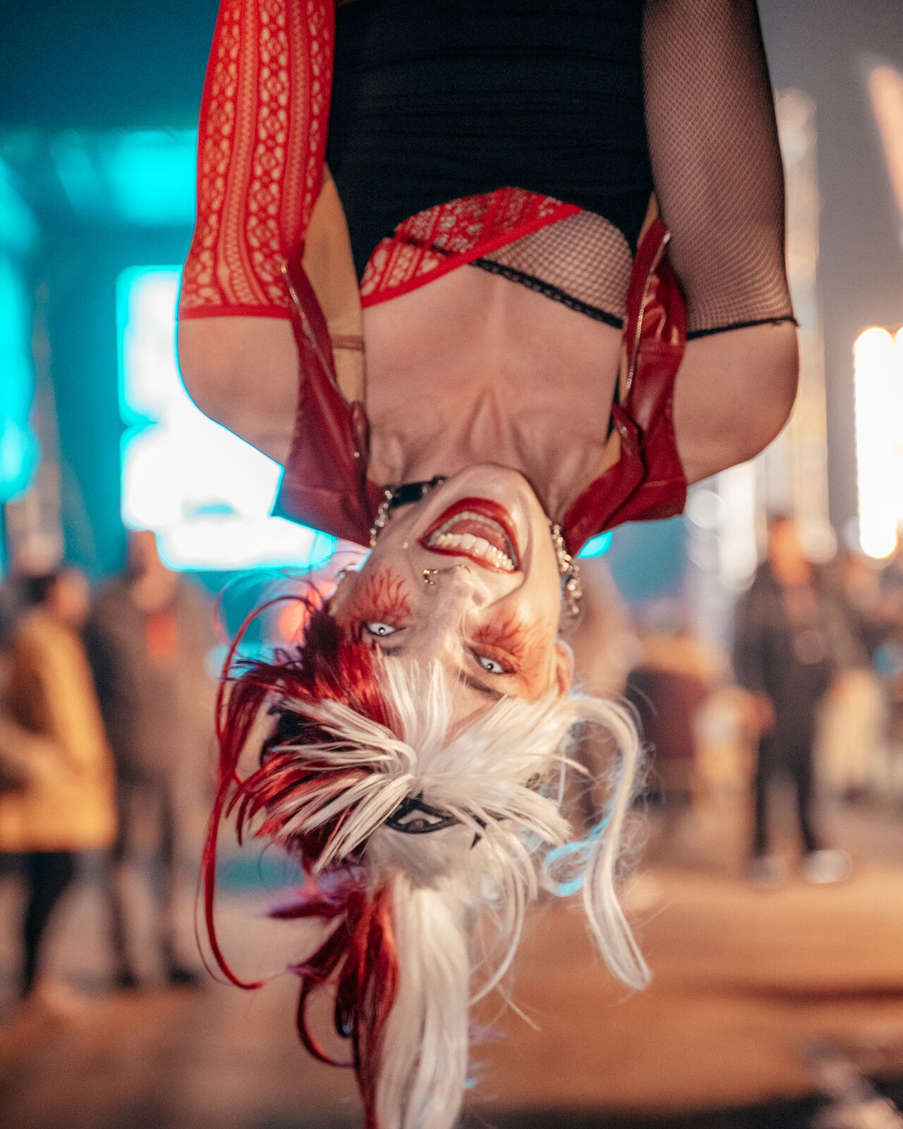 Performer hanging upside down in front of guests